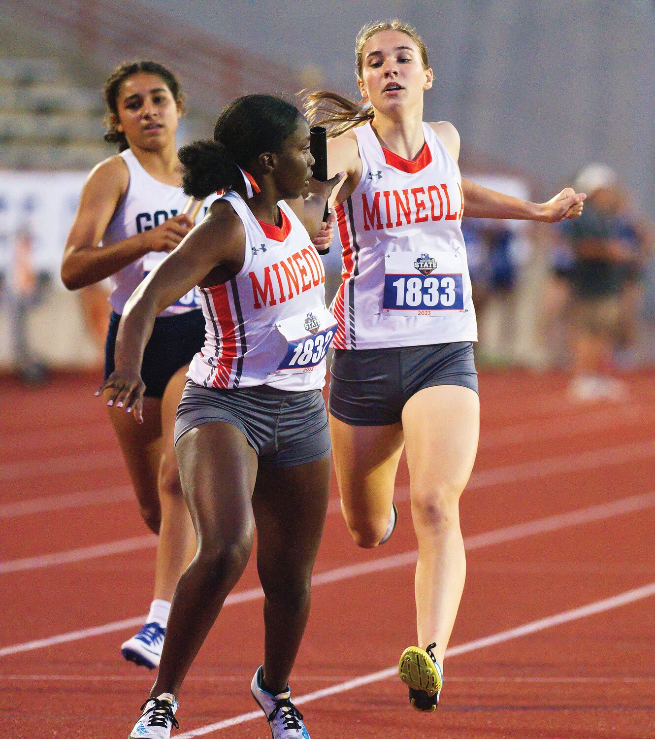 Shylah Kratzmeyer receives the baton from Raylie Peebles for the second leg of the 4x400-meter relay at the state track meet in Austin. [view more relay running]
